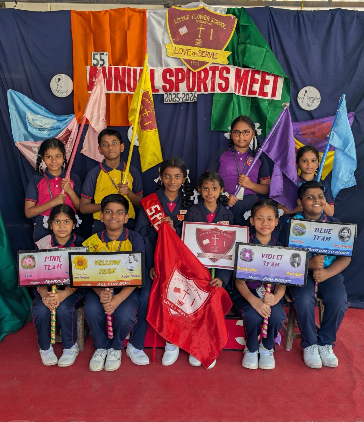 Little Flower School students at the Annual Sports Meet with their house team boards